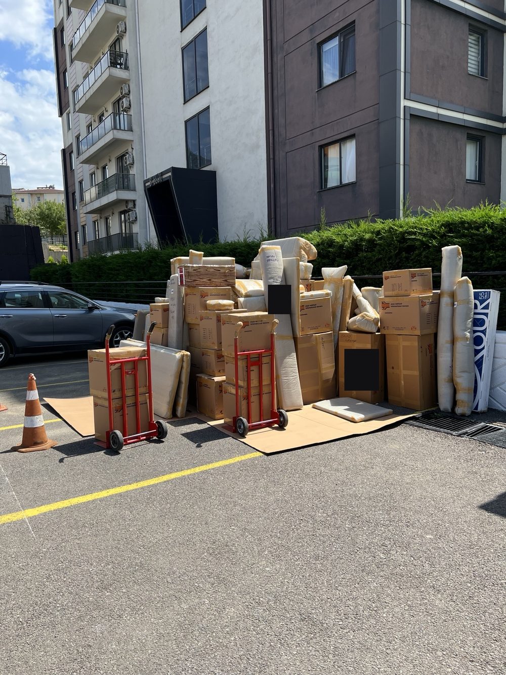 Packed boxes and wrapped furniture outside before our move from Istanbul.