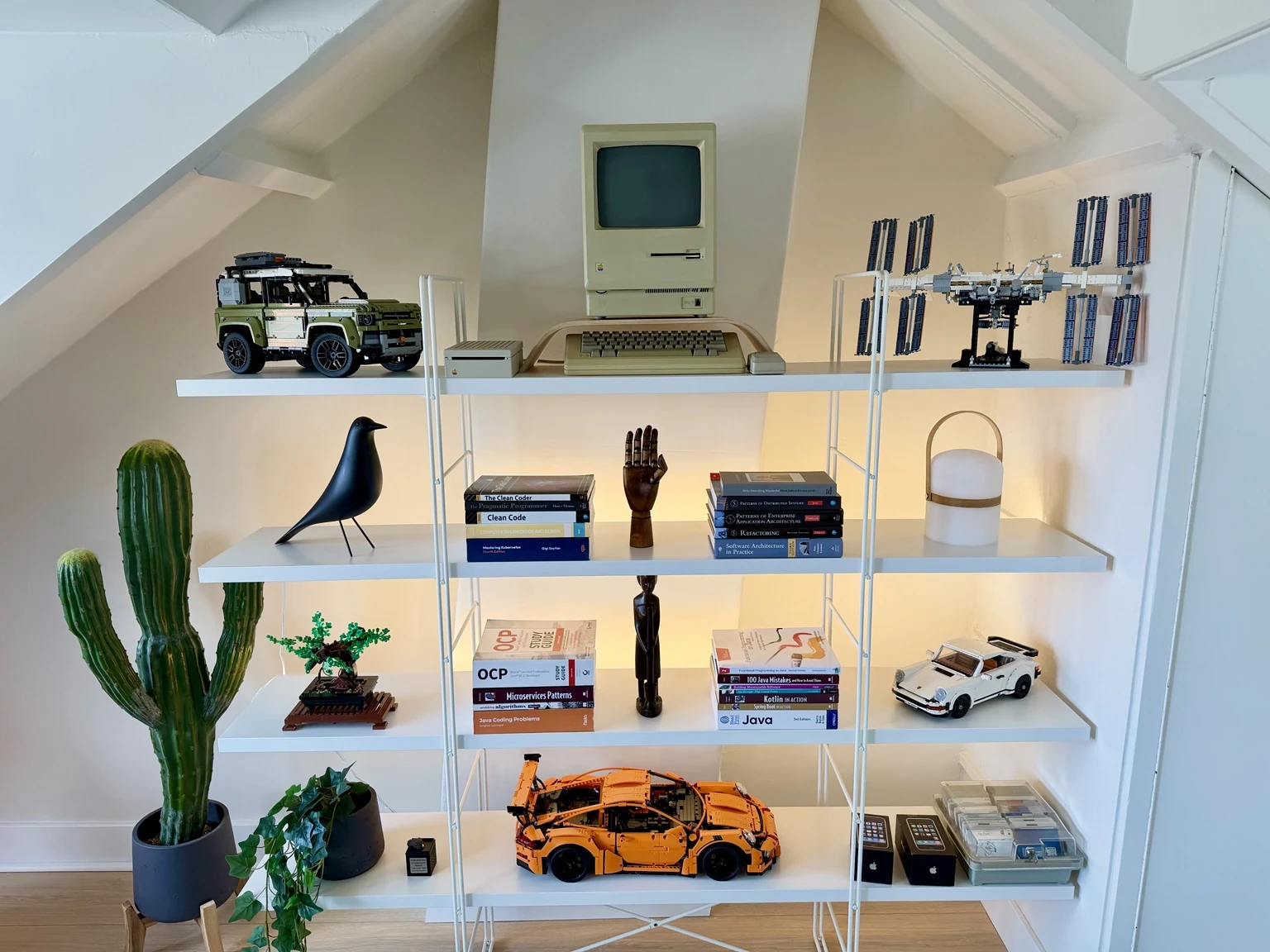 Shelf with Macintosh, books, and collected objects