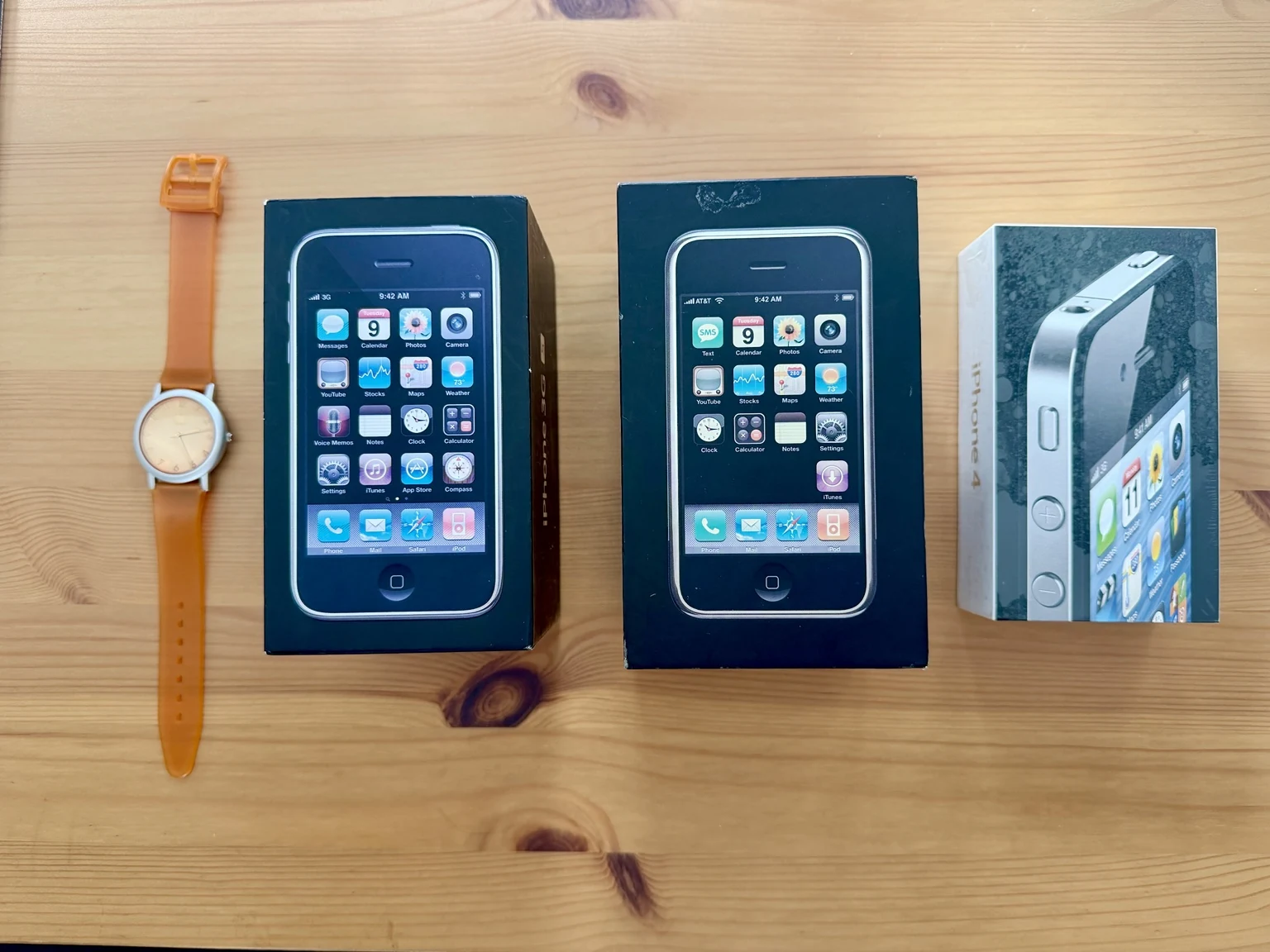 Early iPhone boxes and an orange watch